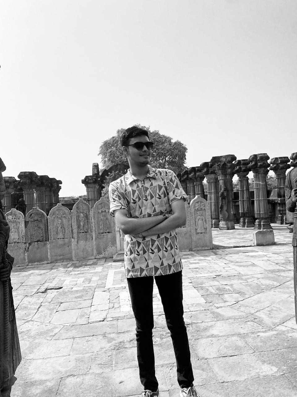 Karan standing at a historic stone site